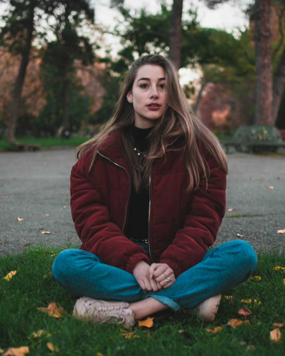 sitting woman wearing maroon zip-up jacket