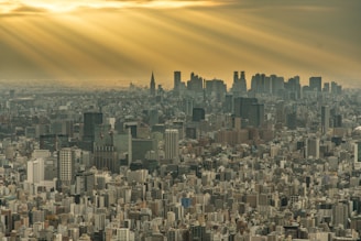 A dramatic drone shot over a bustling cityscape in the northwest of England during golden hour.