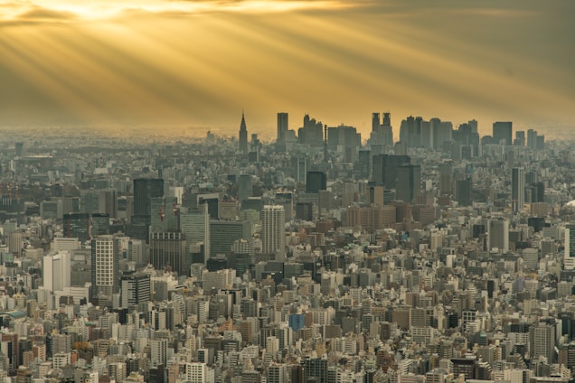 A dramatic drone shot over a bustling cityscape in the northwest of England during golden hour.