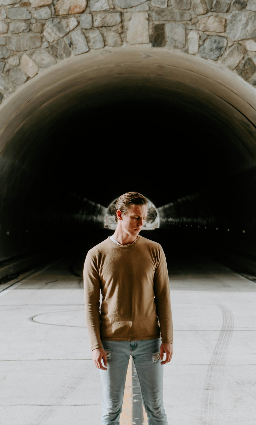 man standing near tunnel