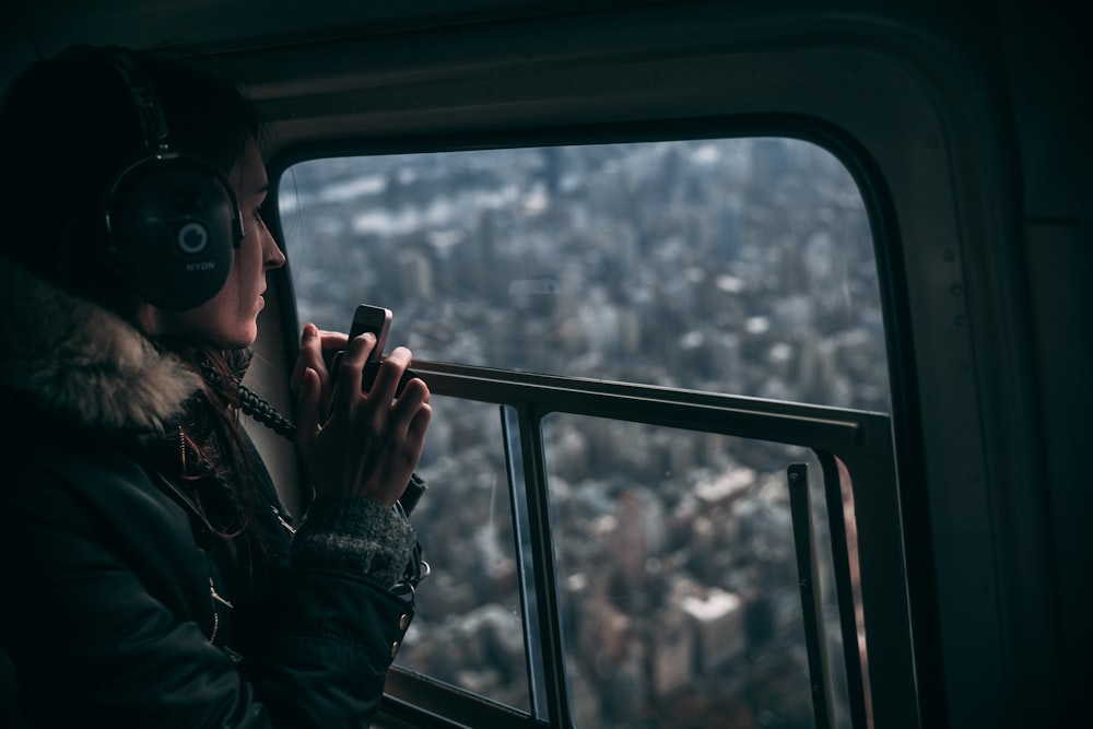 woman sitting beside glass surafce