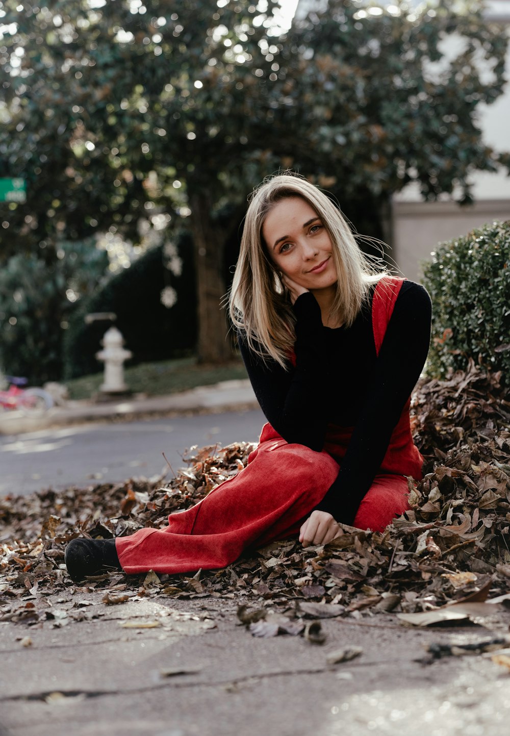 woman sitting on brown leaves