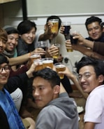 Happy group of friends enjoying a movie night with popcorn and drinks