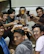 A group of friends celebrating their win, holding up cash prizes with big smiles and high-fives.