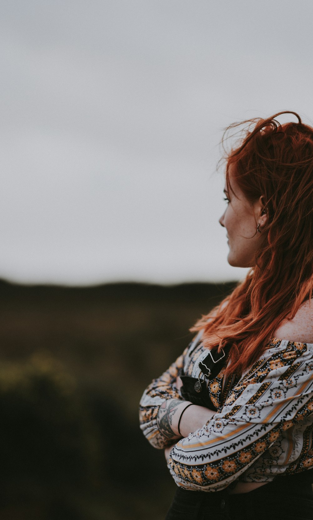 woman wearing white and brown top looking at mountain