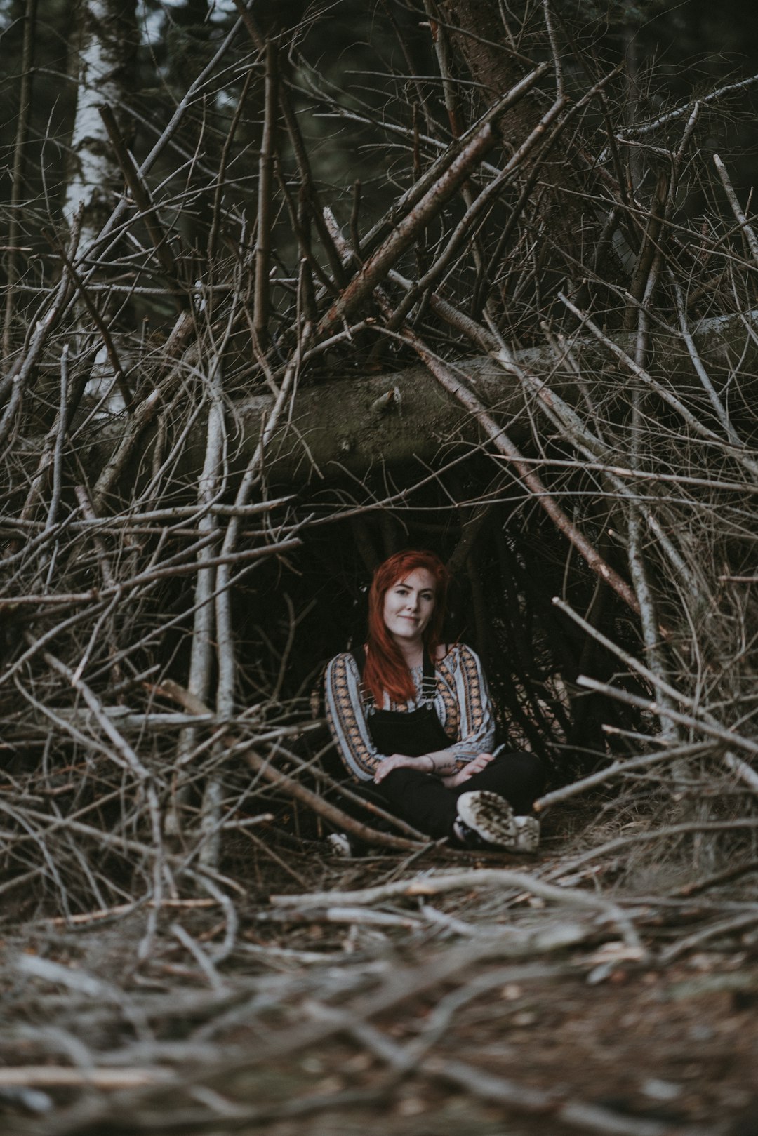 woman sitting under the trees