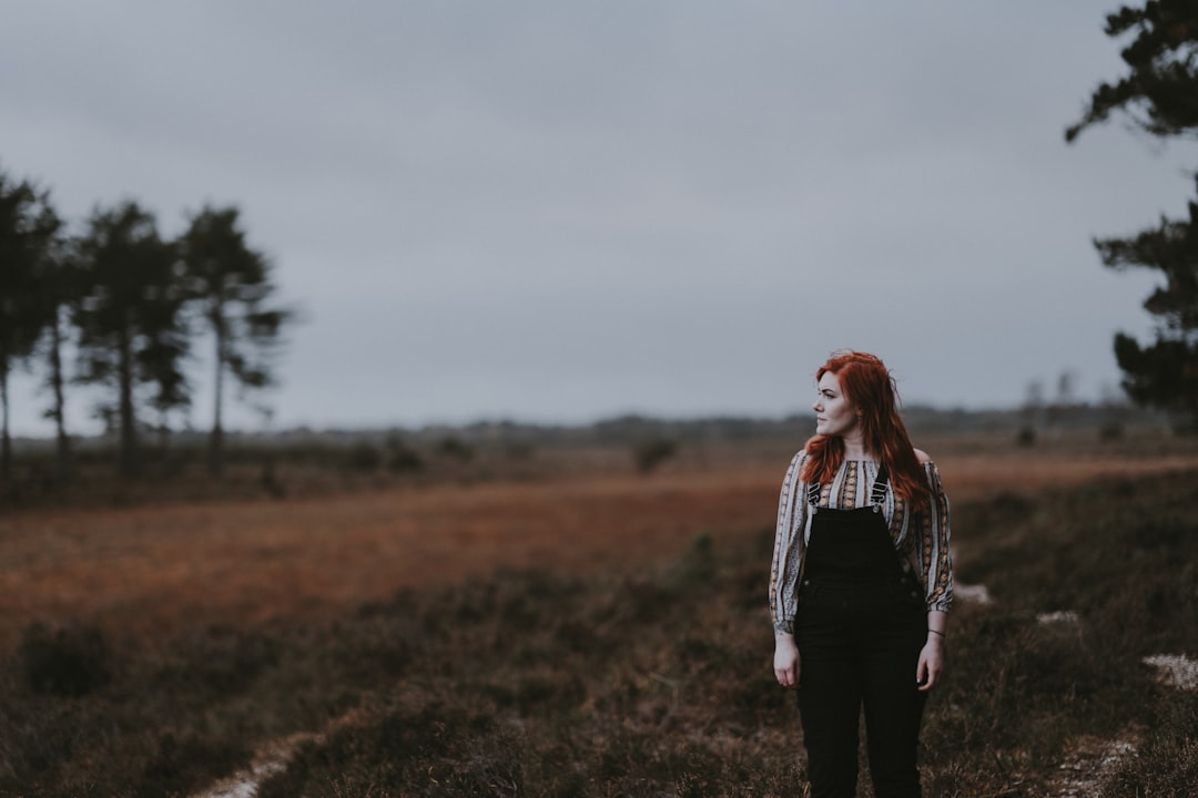 woman standing on green grass field