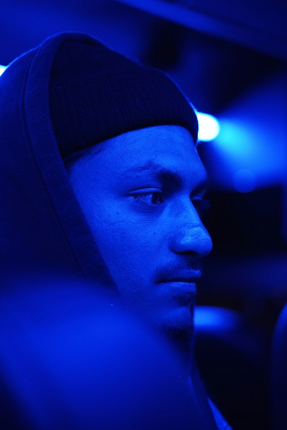 selective focus photography of man wearing knit hat and hooded jacket