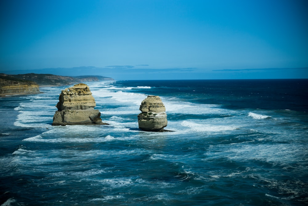 rock fomations on body of water