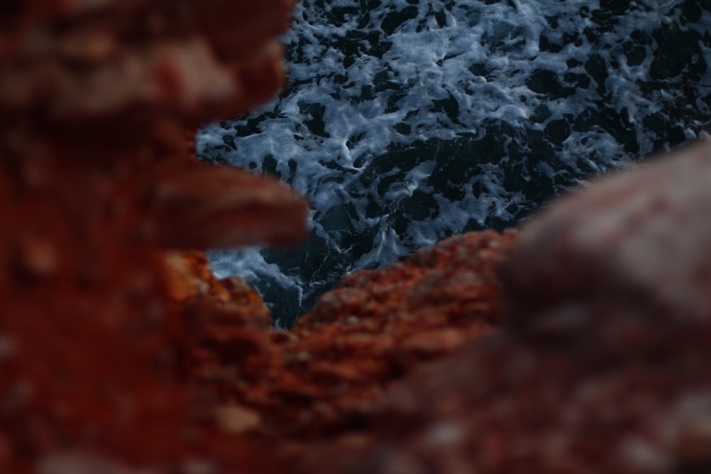 brown rocks overlooking body of water