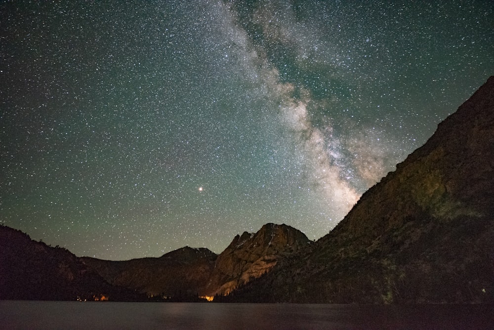 landscape photo of mountain under starry night