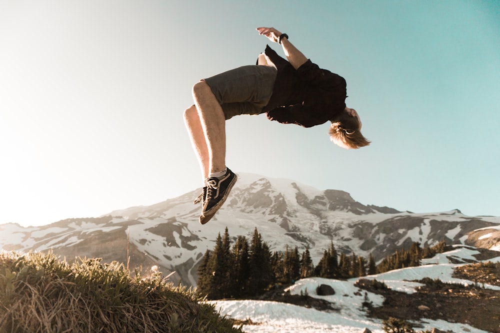 man back tumbling on cliff