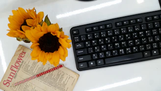 An inviting workspace with a laptop displaying the بالعربي website and colorful Arabic letters scattered around.