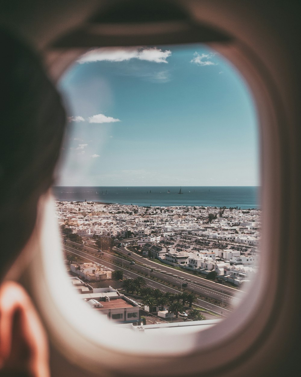 person near airplane window