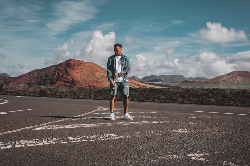 man standing on road