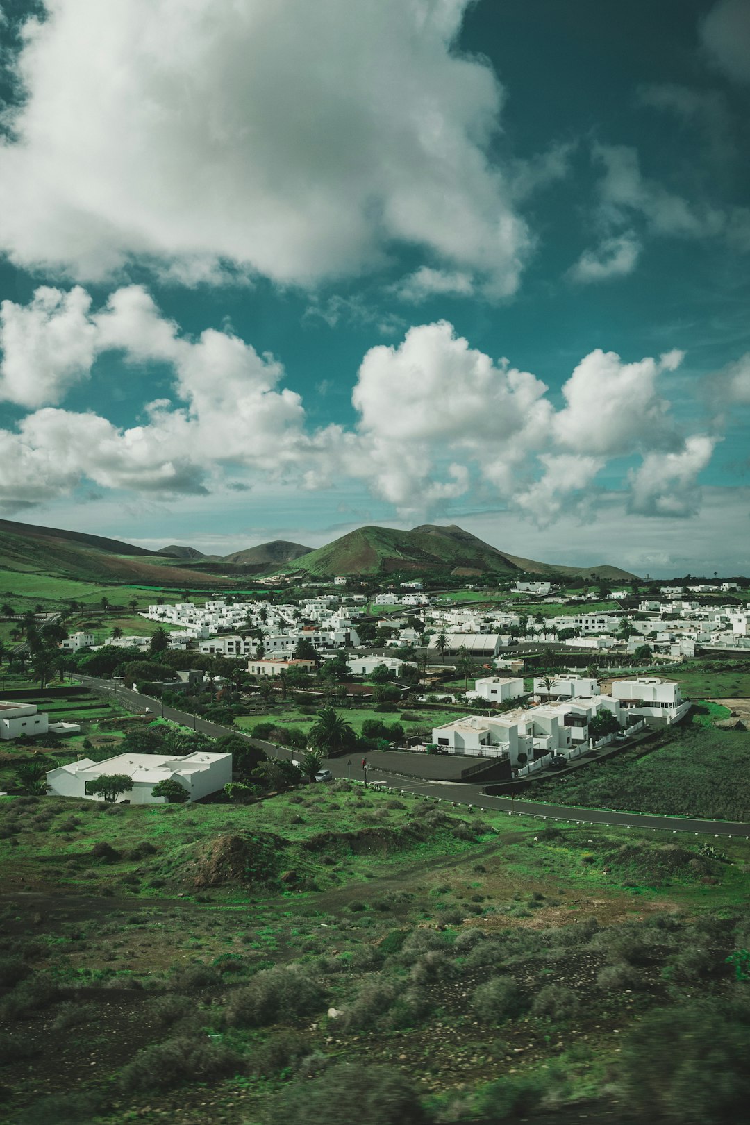 landscape photo of buildings near mountains during daytime