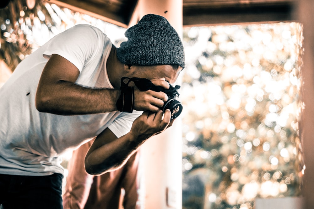 man holding camera during daytime