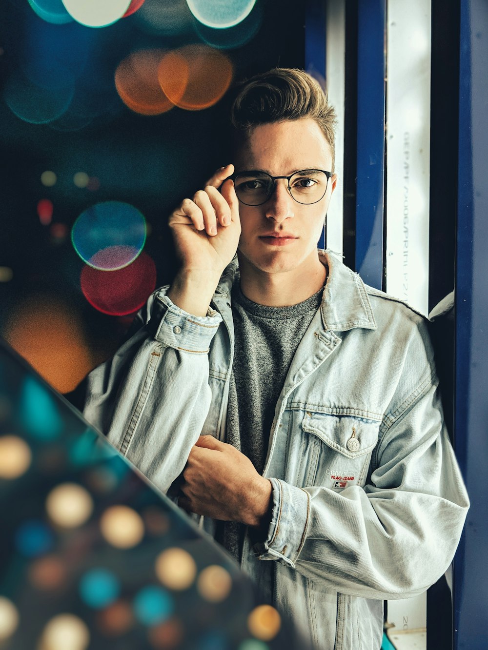 man standing wearing blue denim jacket