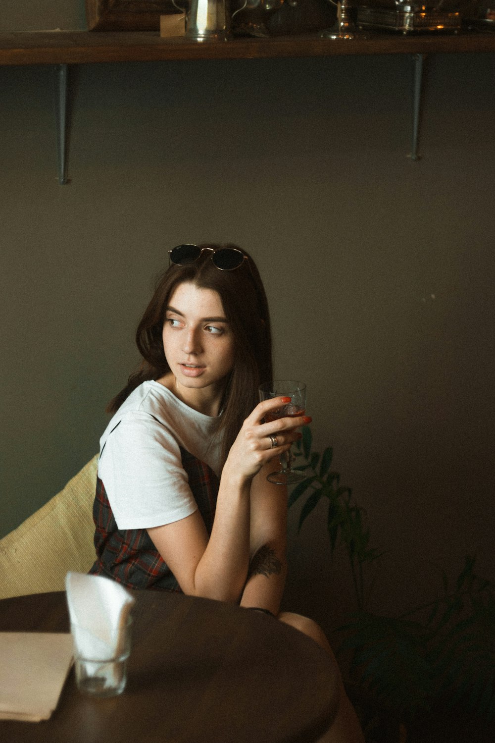 woman wearing white shirt sitting on chair