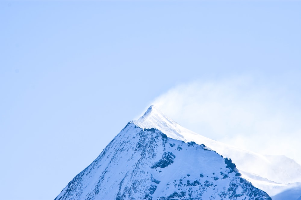 snow covered mountain under blue sky