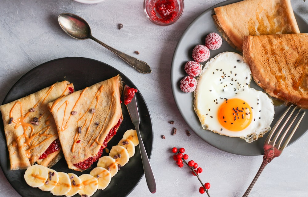 fried egg, bread and raspberry on plate