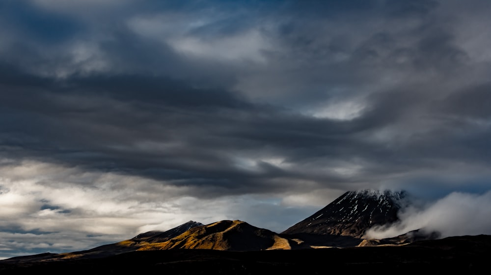 mountains under grey clouds