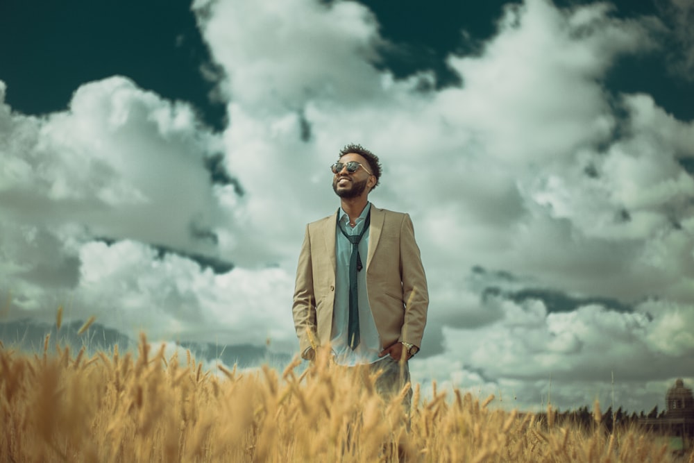 man standing between rice paddy during daytime