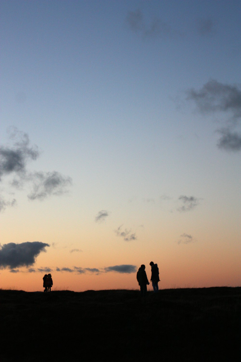 silhouette photography of four people standing