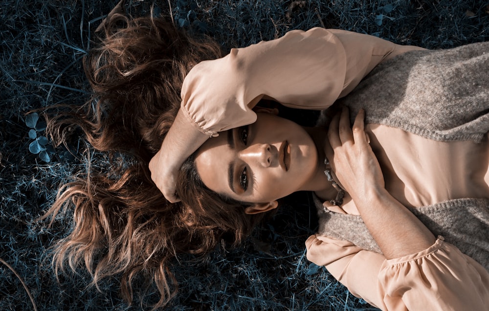 woman in peach satin dress lying on floor