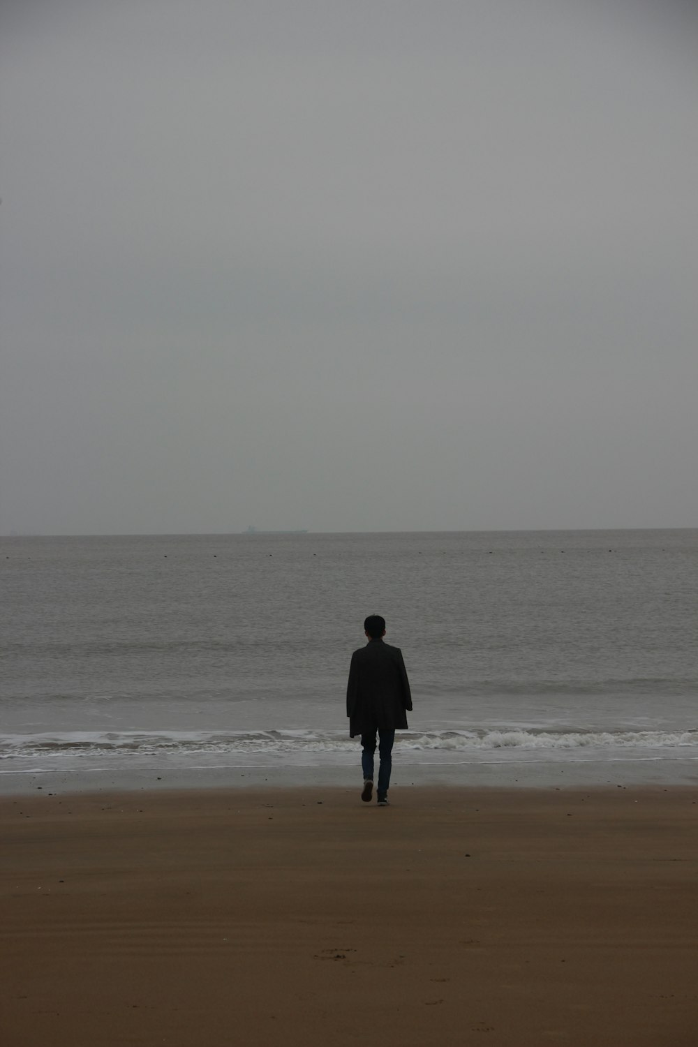 man walking through shore