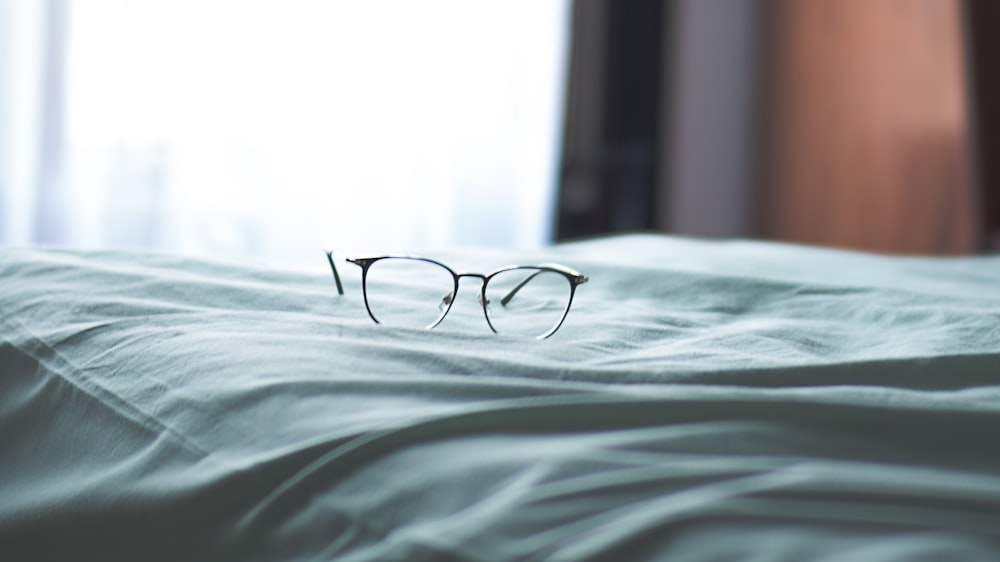 black framed eyeglasses on white linen