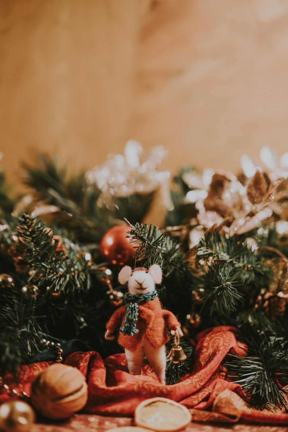 white rodent and green pine leaves