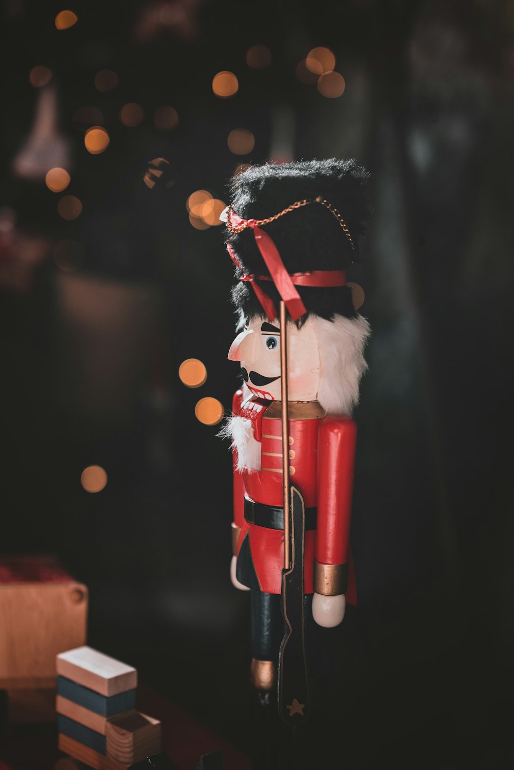 red and black nutcracker figurine in closeup photo