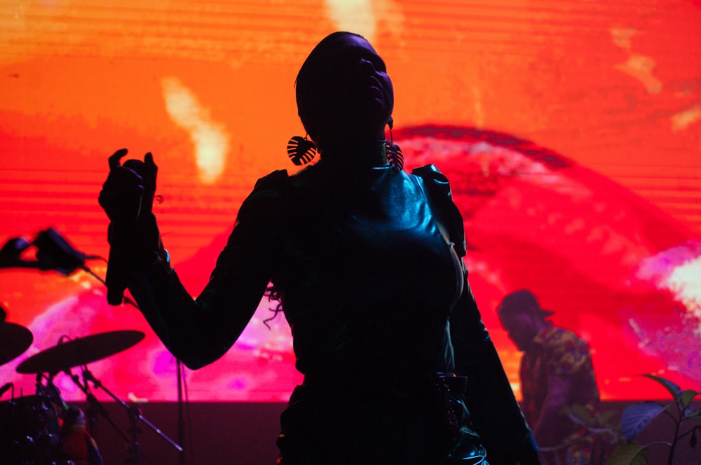 woman on stage holding microphone