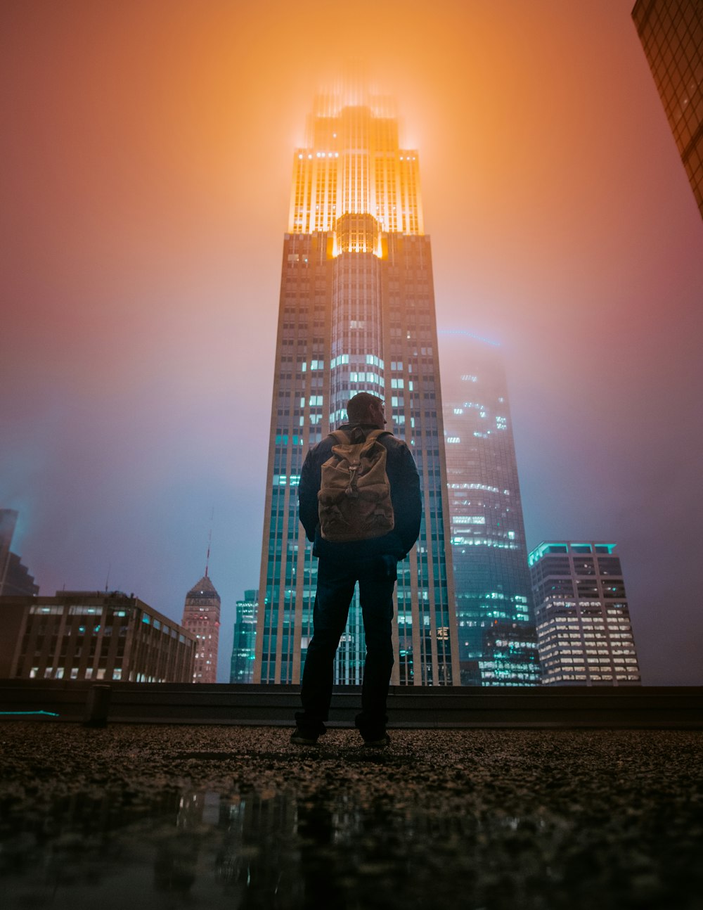 man standing while facing building