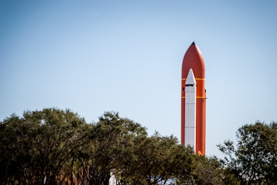 red tower near tree space shuttle zoom background
