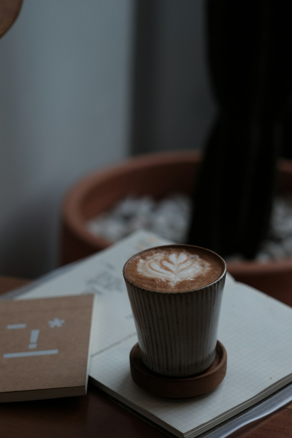 cappuccino in cup on opened book\