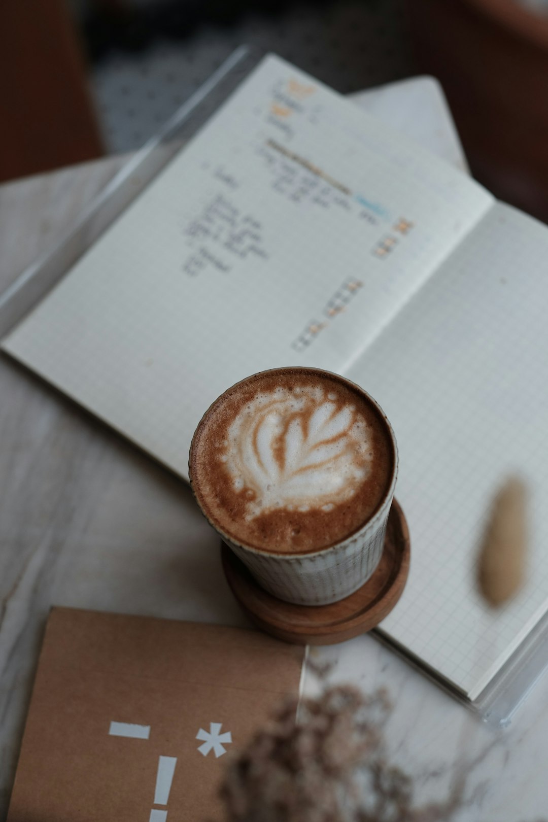 cappuccino in cup beside books