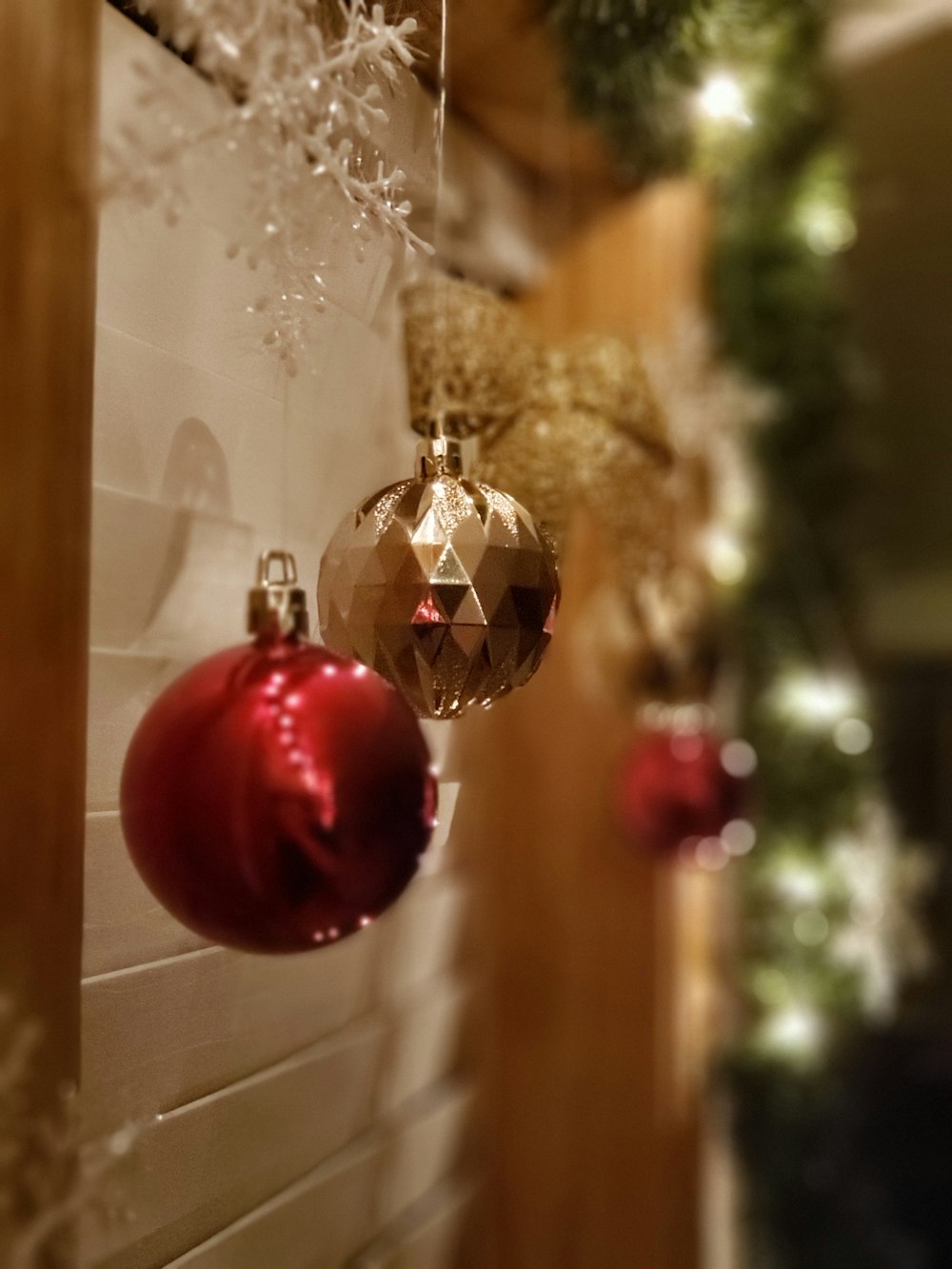 two gray and red baubles hanging beside wall