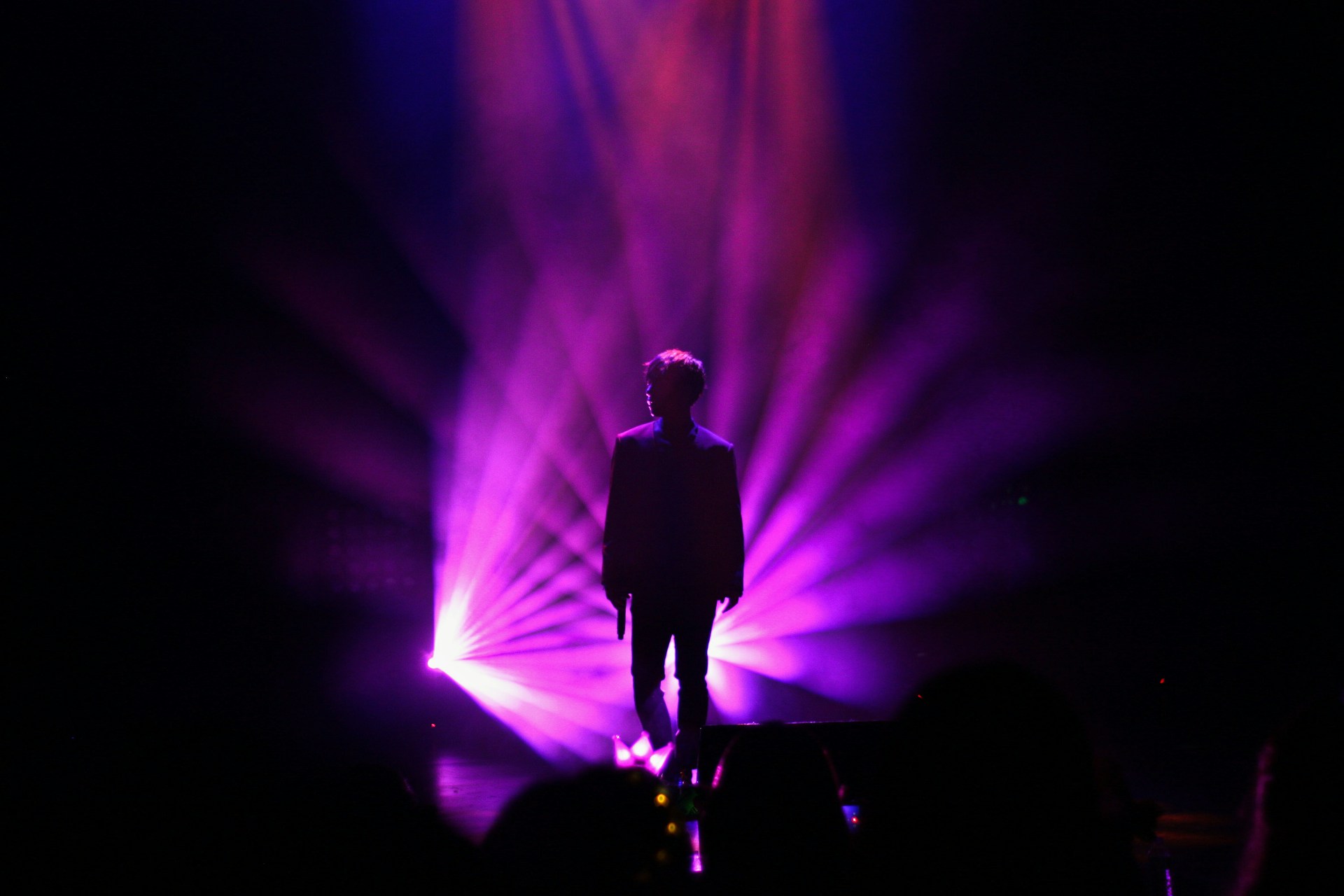 Stephanie performing on a dimly lit stage with deep red and purple hues, the atmosphere thick with soulful intensity.