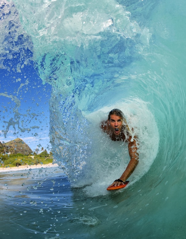 man surfing on ocean waves during daytime