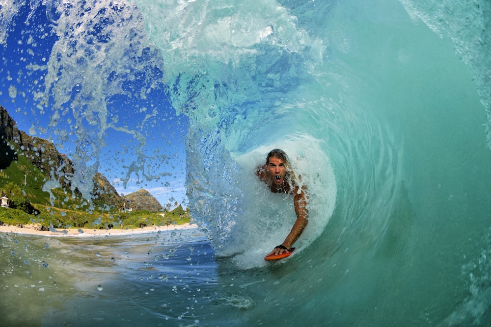 man surfing on ocean waves during daytime