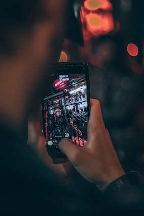 A professional photographer capturing a 360-degree photo of a modern storefront.