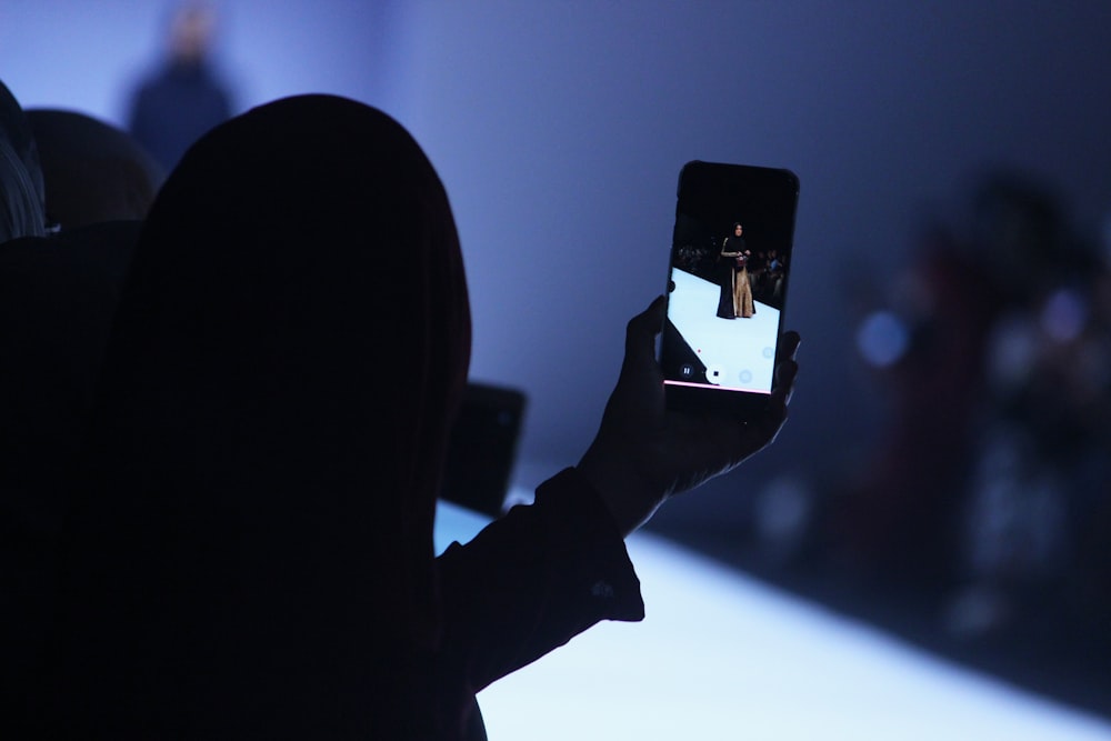 person using phone doing video of woman