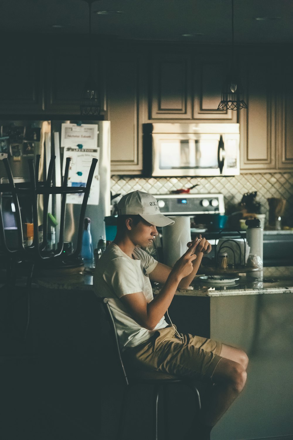 man sitting on chair beside table