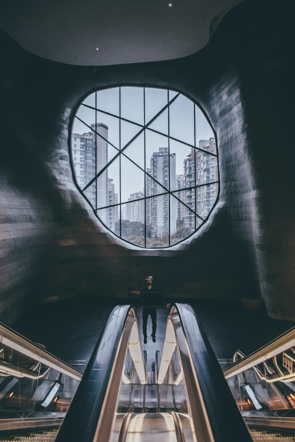 person standing on escalator insidebuilding