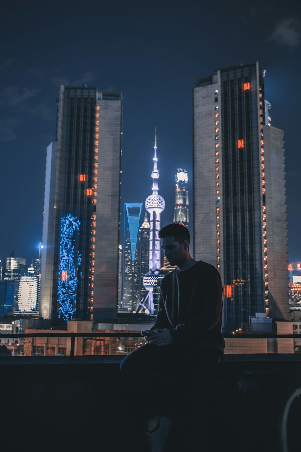 man sitting near railings