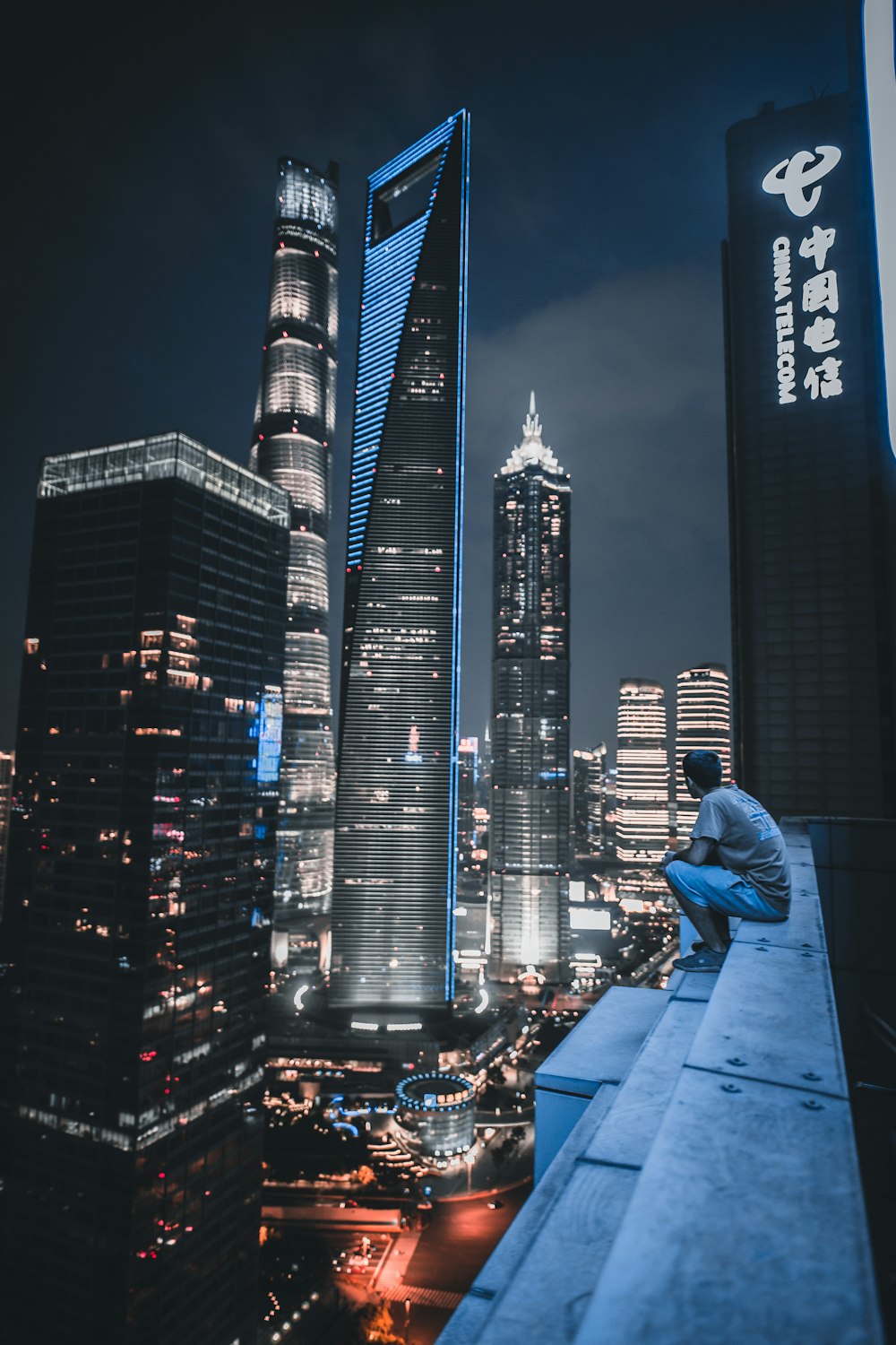 man sitting on roof top viewing city view