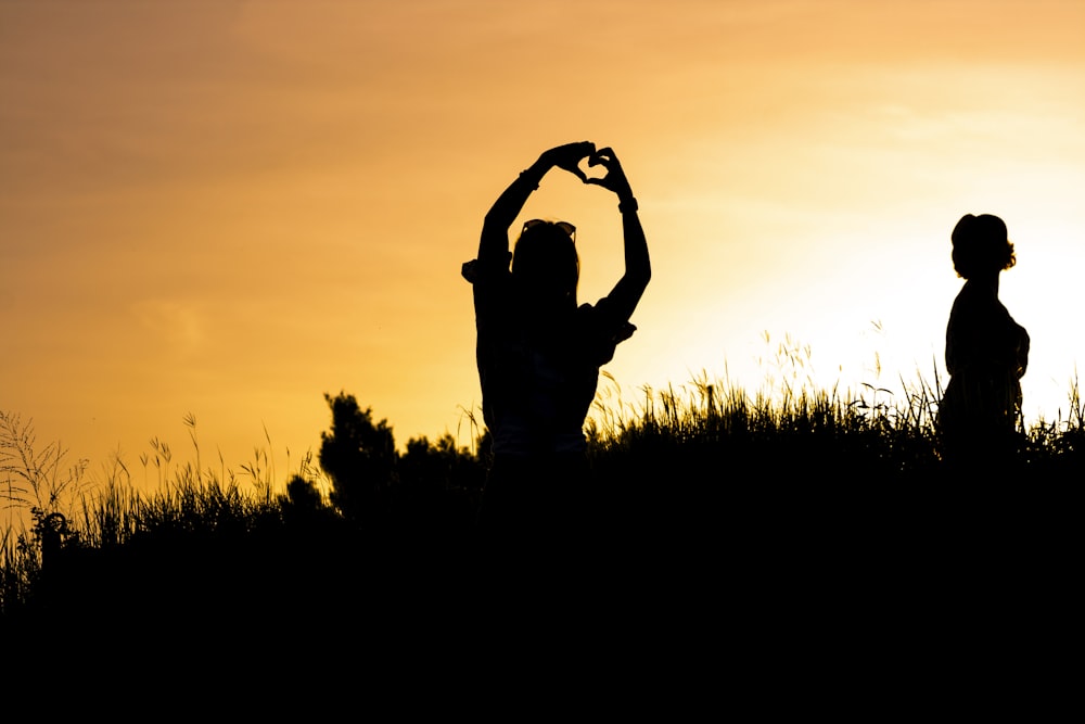 woman doing heart hand sign