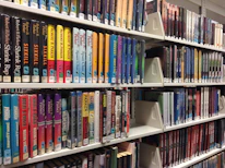 Close-up of colorful books stacked neatly in a community library.